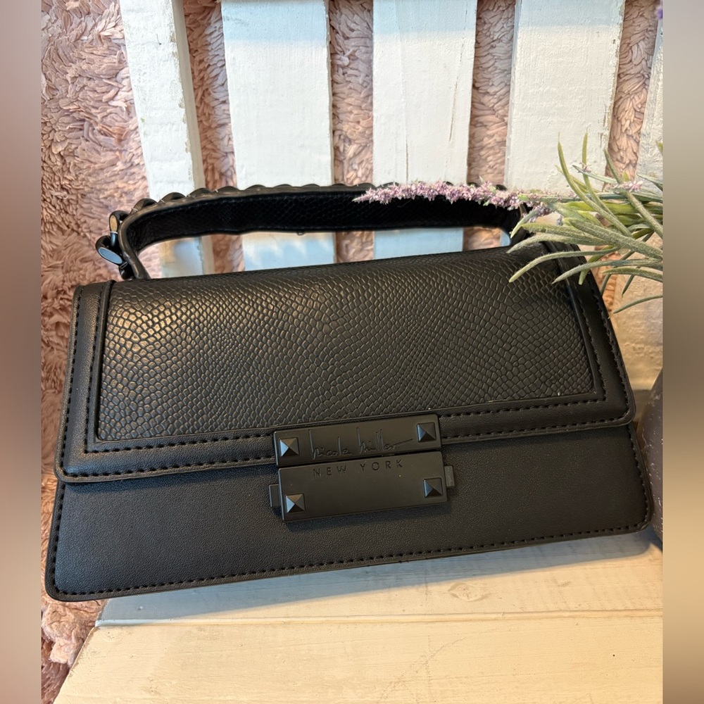 Nicole Miller small Leather and bag with cross body straps.